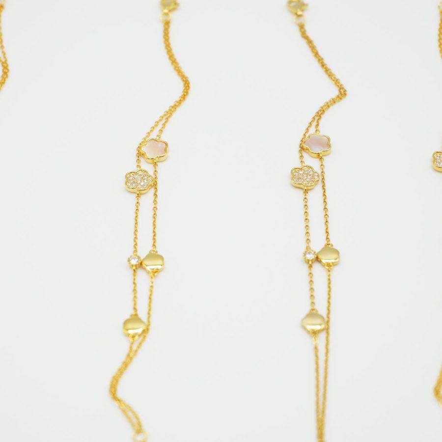 Gold bracelet with small clover charms