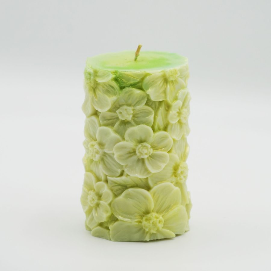 Handcrafted pillar candle featuring embossed floral patterns, perfect for ambient lighting and decoration.