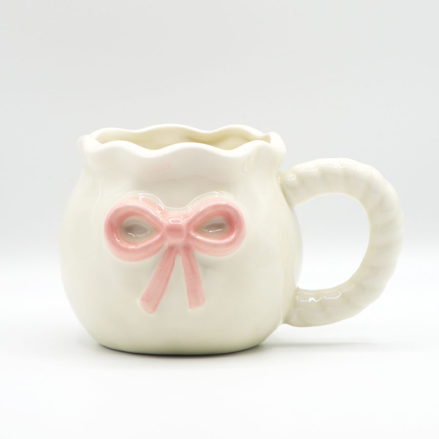Dainty white ceramic coffee mug with a pastel pink bow embellishment