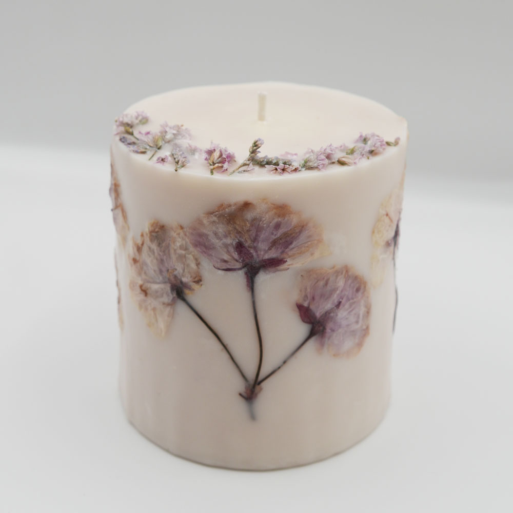 Handcrafted botanical candle decorated with natural eucalyptus leaves and scented with eucalyptus and lavender.