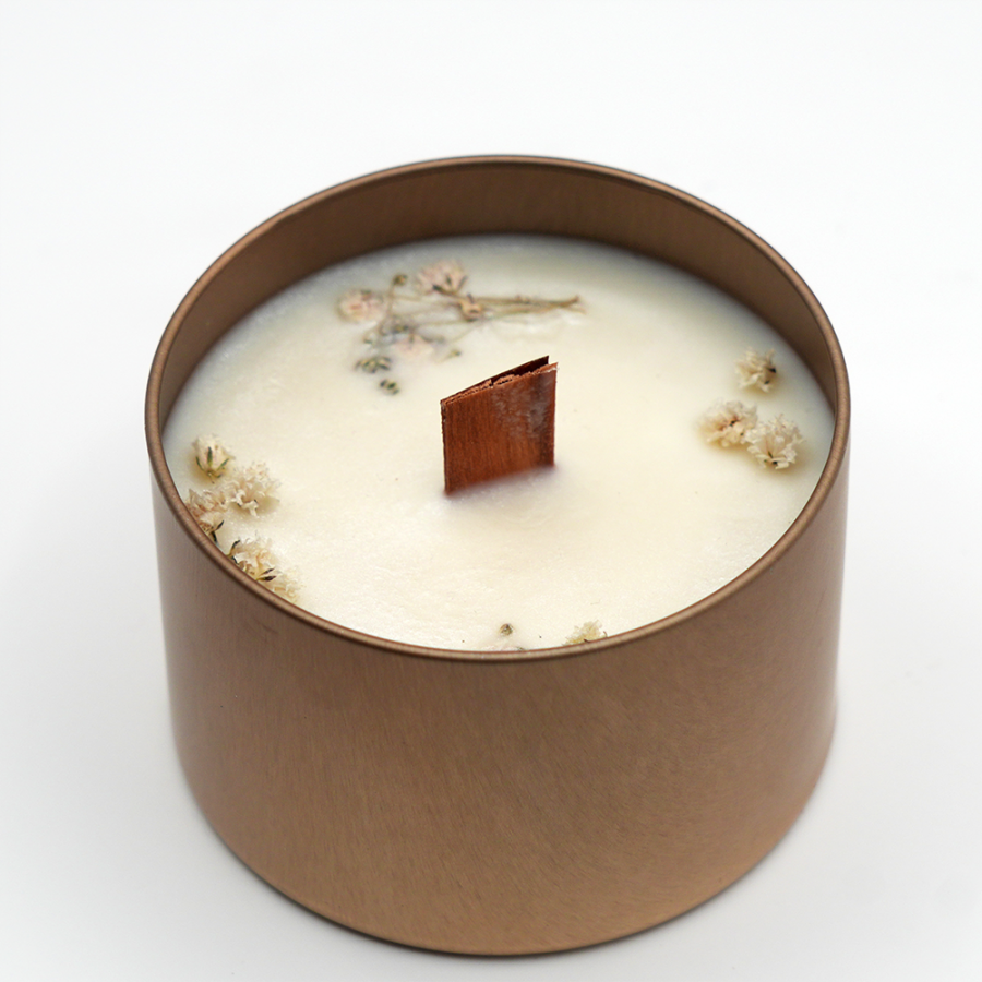 Handcrafted golden jar candle made with 100% soy wax and a natural wooden wick.