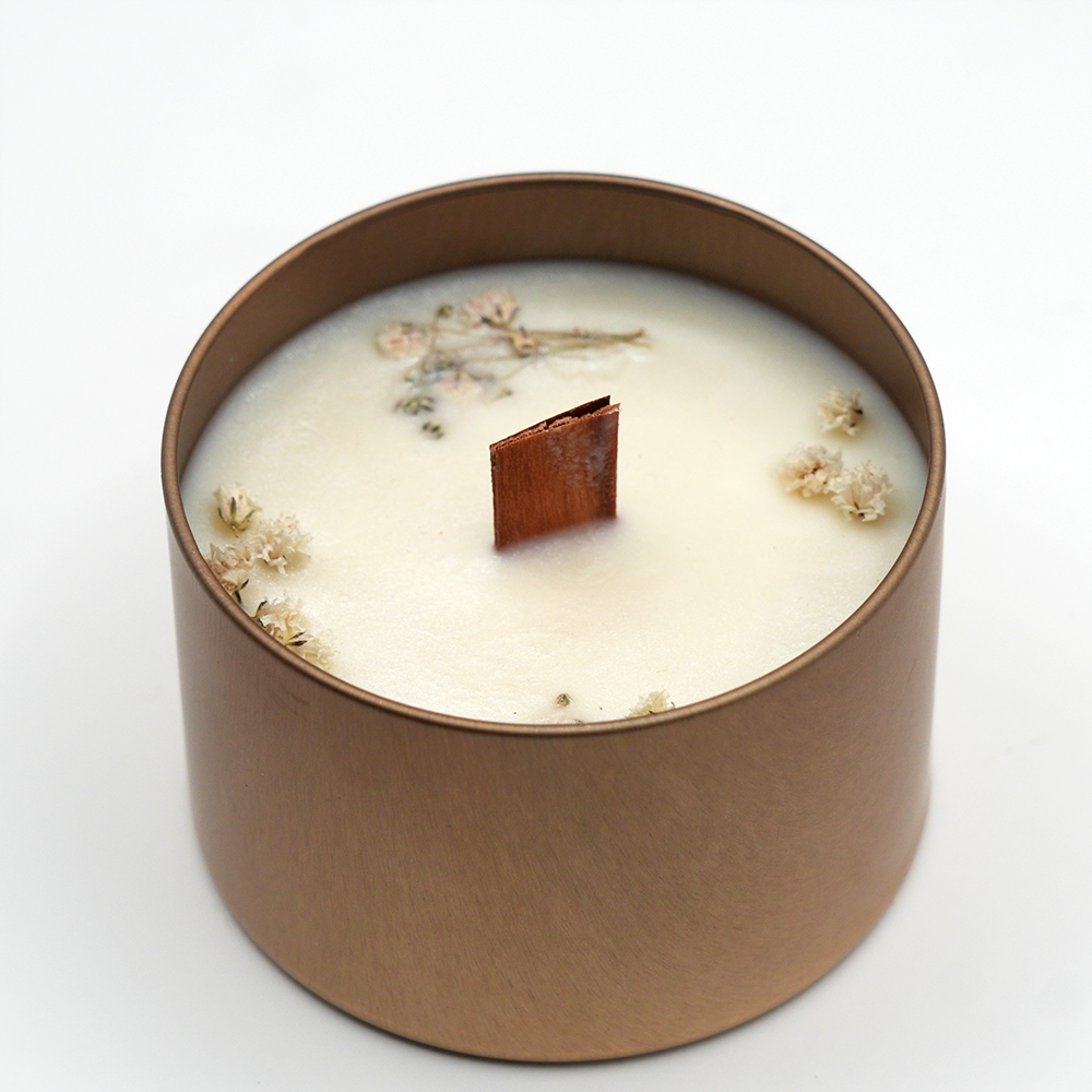 Handcrafted golden jar candle made with 100% soy wax and a natural wooden wick.